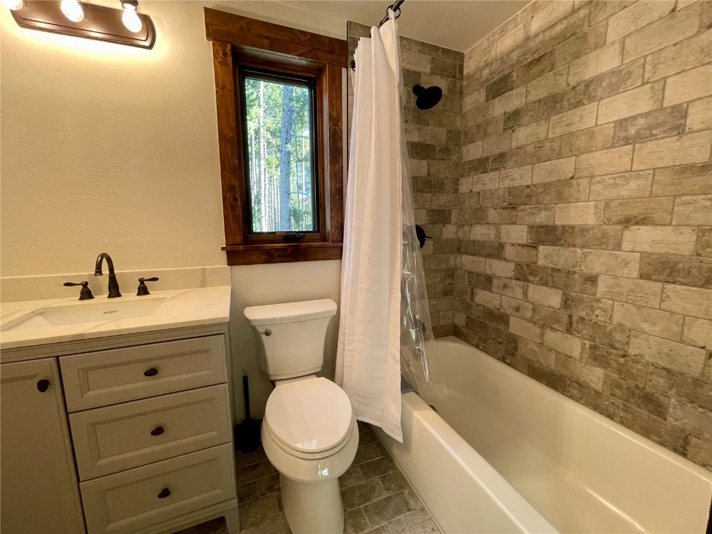 204 Blue Ridge Road Breckenridge, CO 80424 - Photo 14 of 40 Full bathroom featuring vanity, shower / bath combination with curtain, and toilet