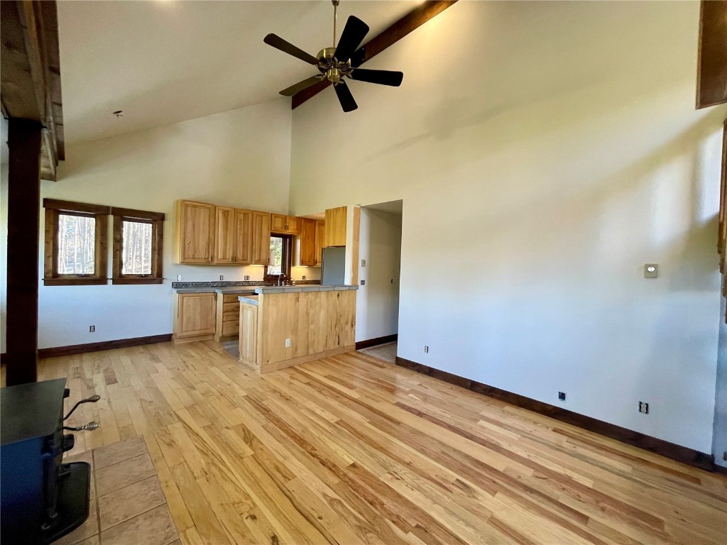 204 Blue Ridge Road Breckenridge, CO 80424 - Photo 6 of 40 Kitchen with light brown cabinets, high vaulted ceiling, light wood-type flooring, and ceiling fan