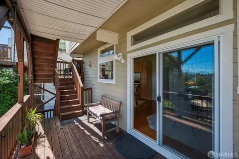 a view of a kitchen with stainless steel appliances granite countertop a stove and a sink