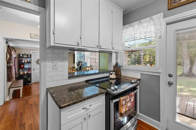 a kitchen with stainless steel appliances granite countertop a refrigerator and a stove