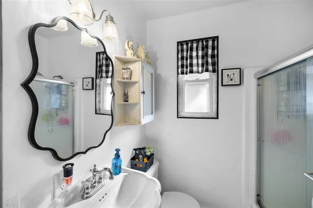 a bathroom with a sink toilet and shower