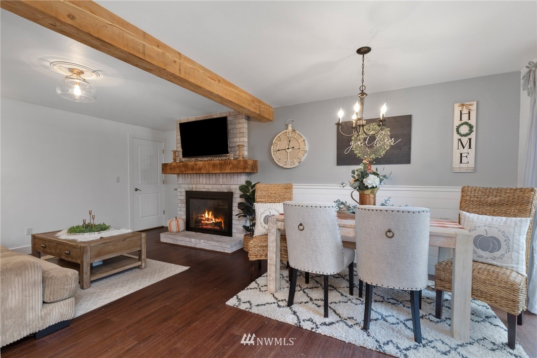 3118 167th Street Southeast Bothell, WA 98012 - Photo 13 of 38 a living room with furniture a fireplace and a flat screen tv