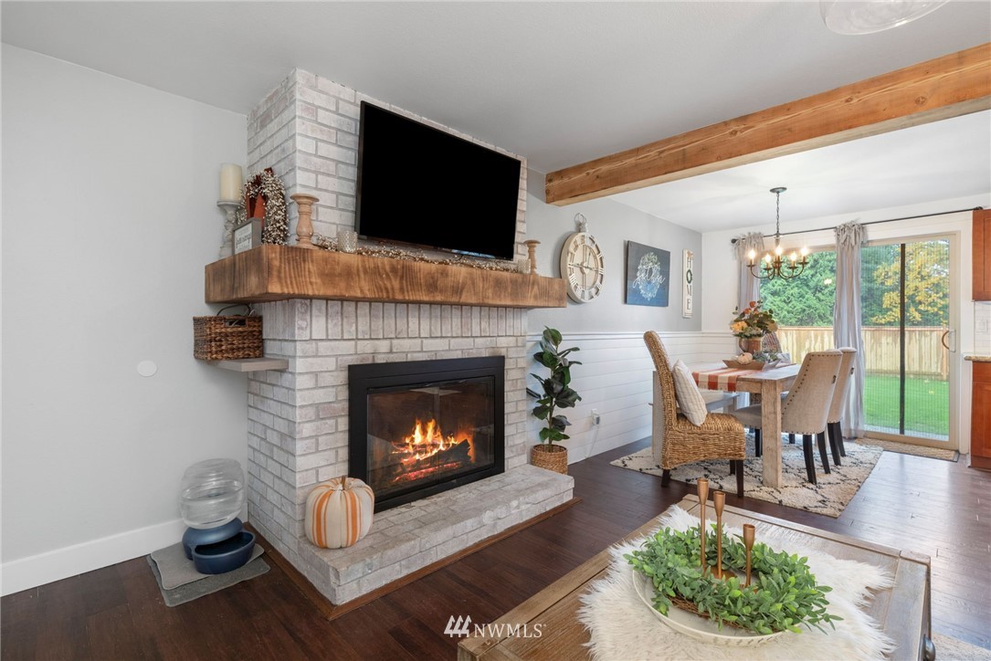 3118 167th Street Southeast Bothell, WA 98012 - Photo 18 of 38 a living room with furniture a flat screen tv and a fireplace