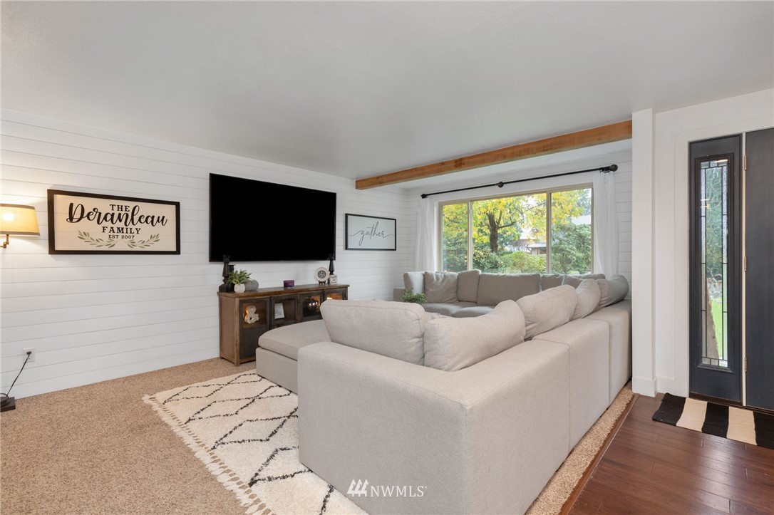 3118 167th Street Southeast Bothell, WA 98012 - Photo 3 of 38 a living room with furniture and a flat screen tv