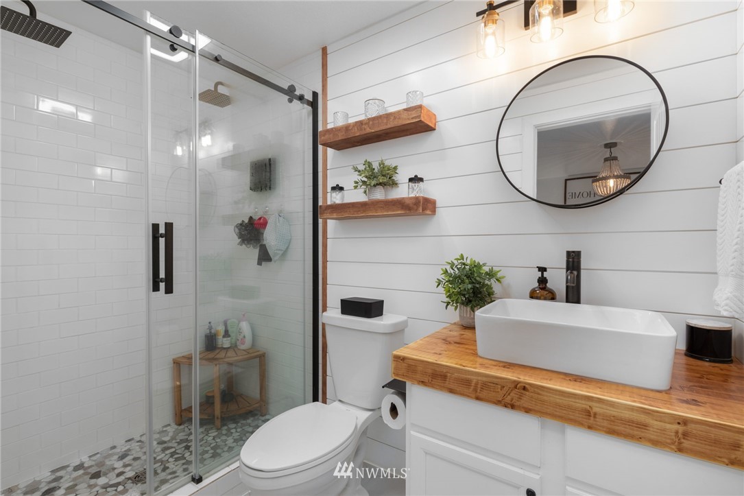 3118 167th Street Southeast Bothell, WA 98012 - Photo 25 of 38 a bathroom with a sink a toilet and a mirror