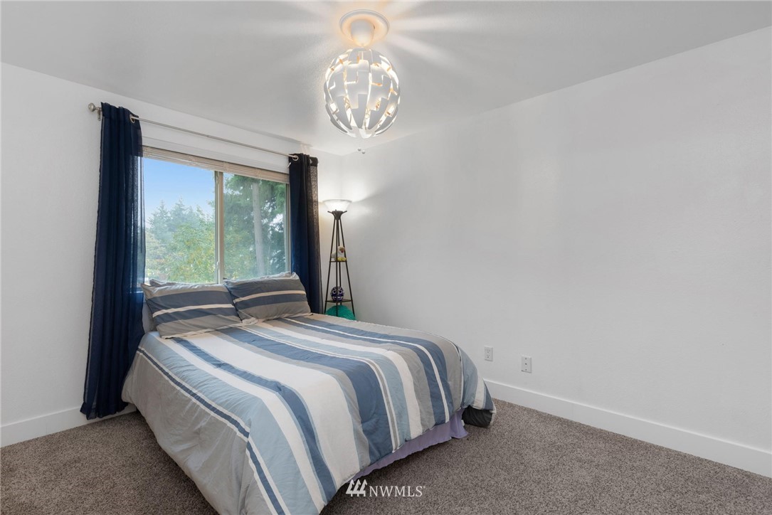 3118 167th Street Southeast Bothell, WA 98012 - Photo 26 of 38 a bedroom with a bed and a window