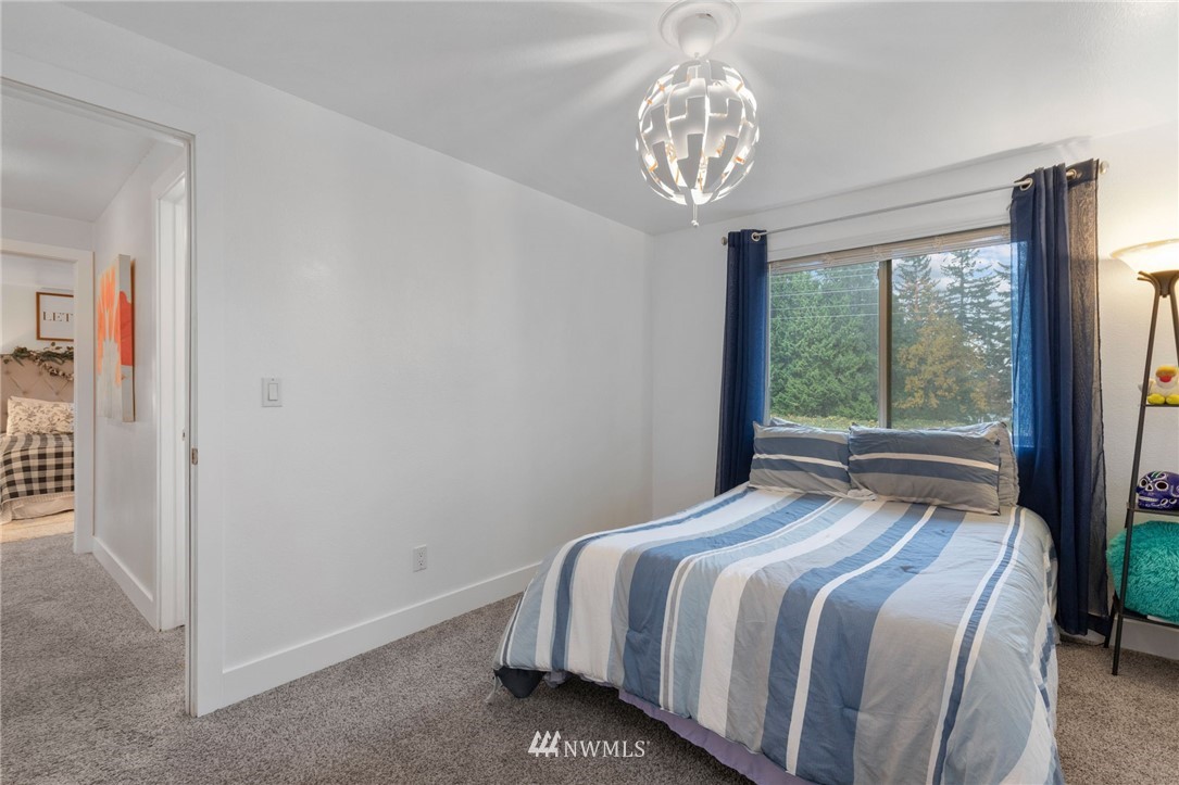 3118 167th Street Southeast Bothell, WA 98012 - Photo 27 of 38 a bedroom with a bed and a large window