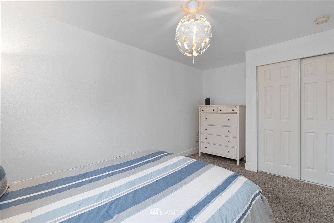 3118 167th Street Southeast Bothell, WA 98012 - Photo 29 of 38 a room with a dresser and a chandelier