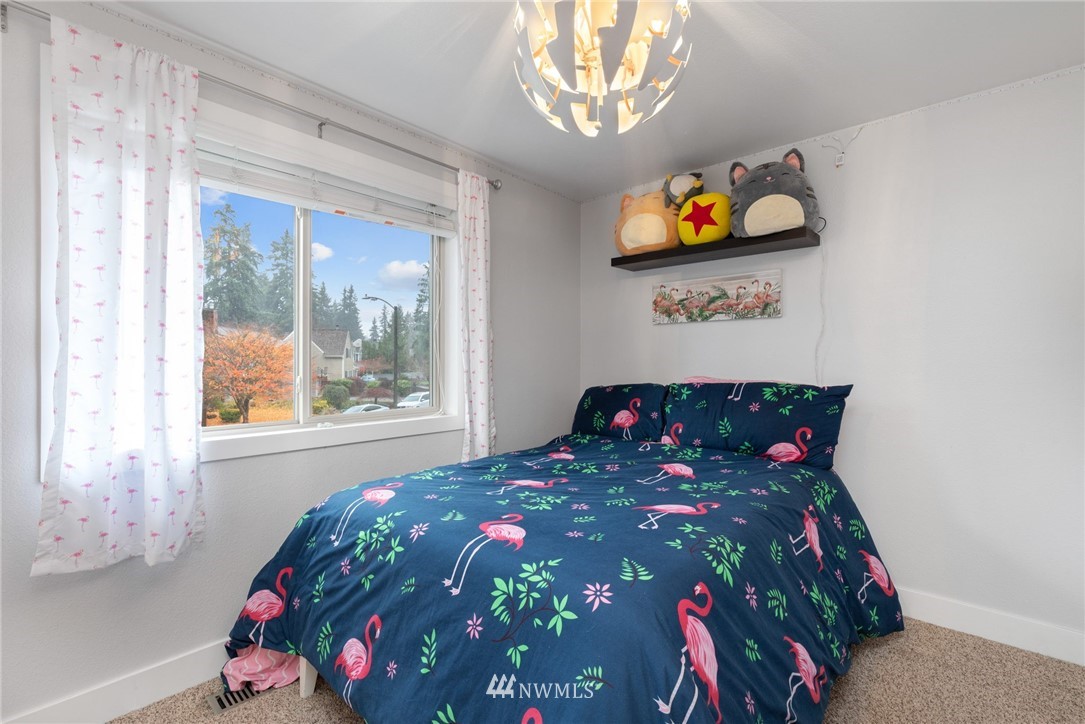 3118 167th Street Southeast Bothell, WA 98012 - Photo 32 of 38 a bed sitting in a bedroom next to a window