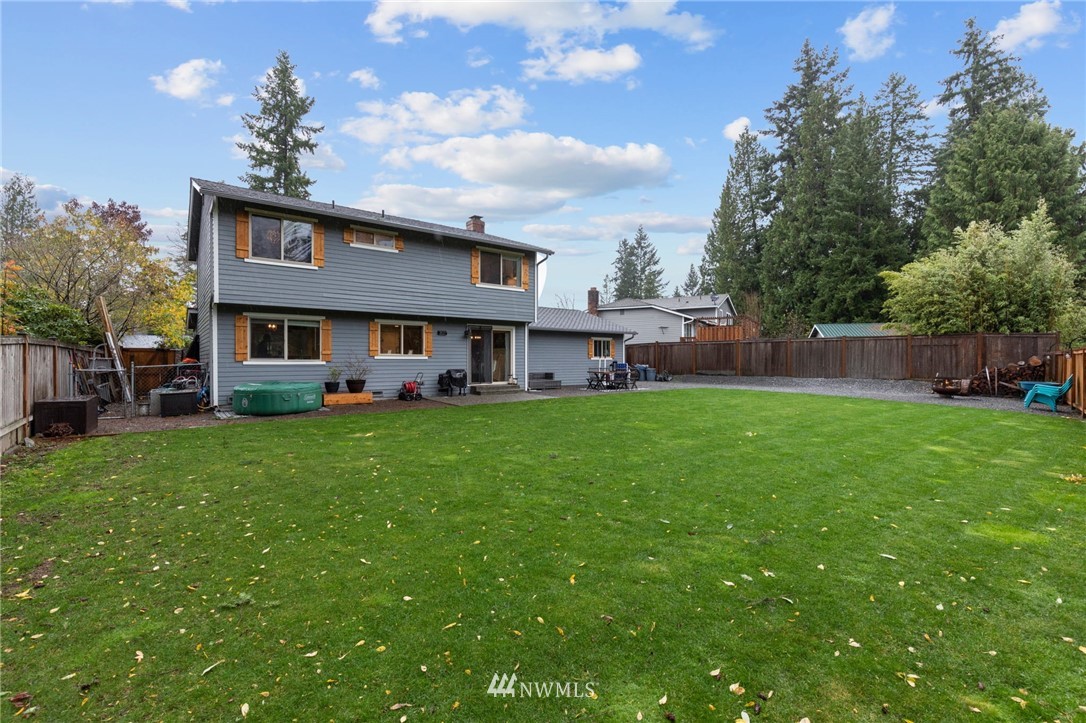3118 167th Street Southeast Bothell, WA 98012 - Photo 35 of 38 a front view of a house with a garden and plants