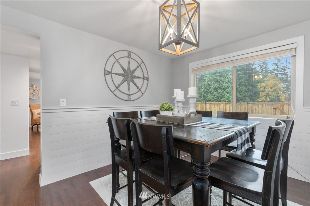 3118 167th Street Southeast Bothell, WA 98012 - Photo 7 of 38 a view of a dining room with furniture window and wooden floor