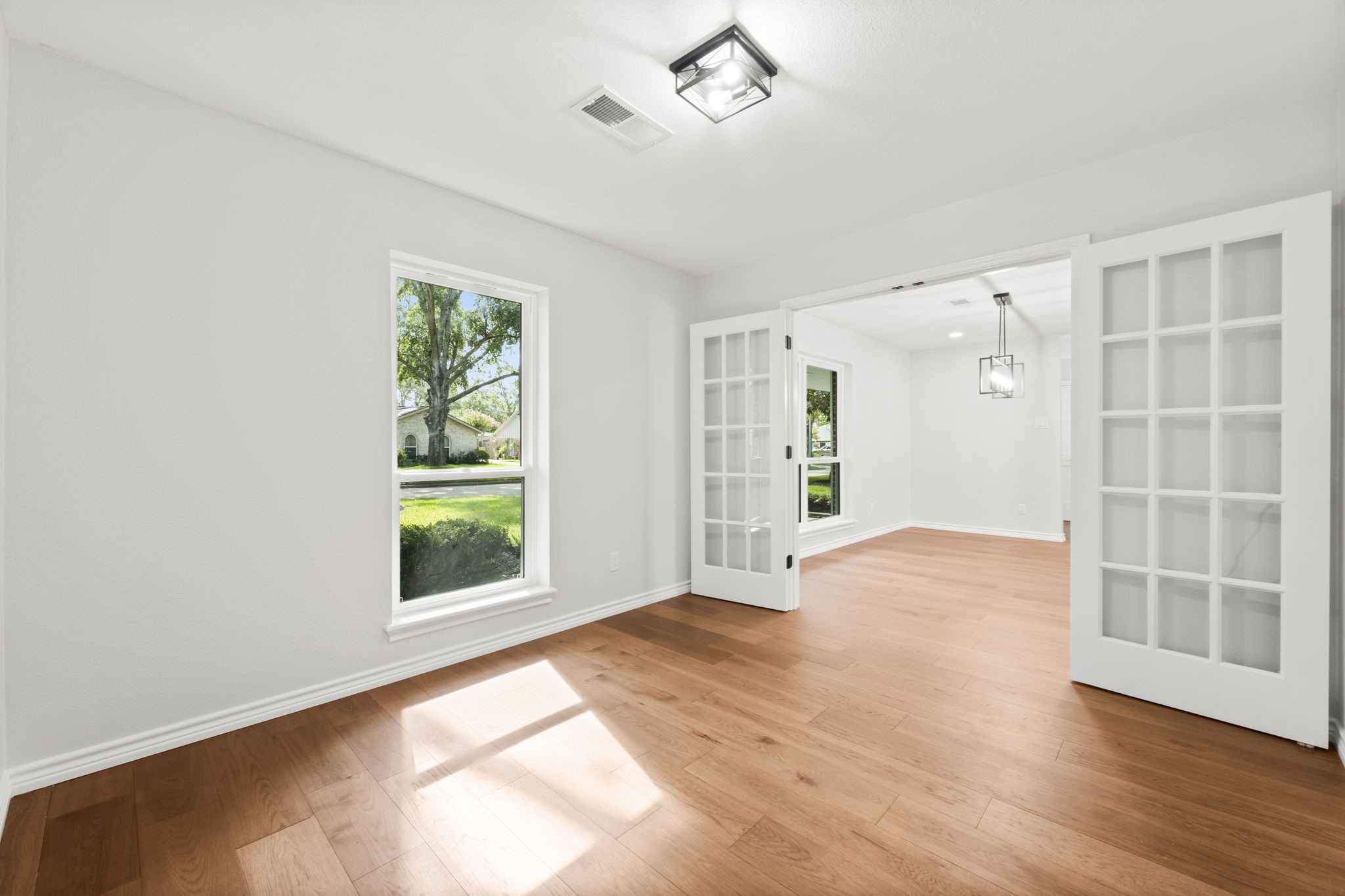 2535 Southwick Street Houston, TX 77080 - Photo 13 of 26 a view of an empty room with a window and wooden floor