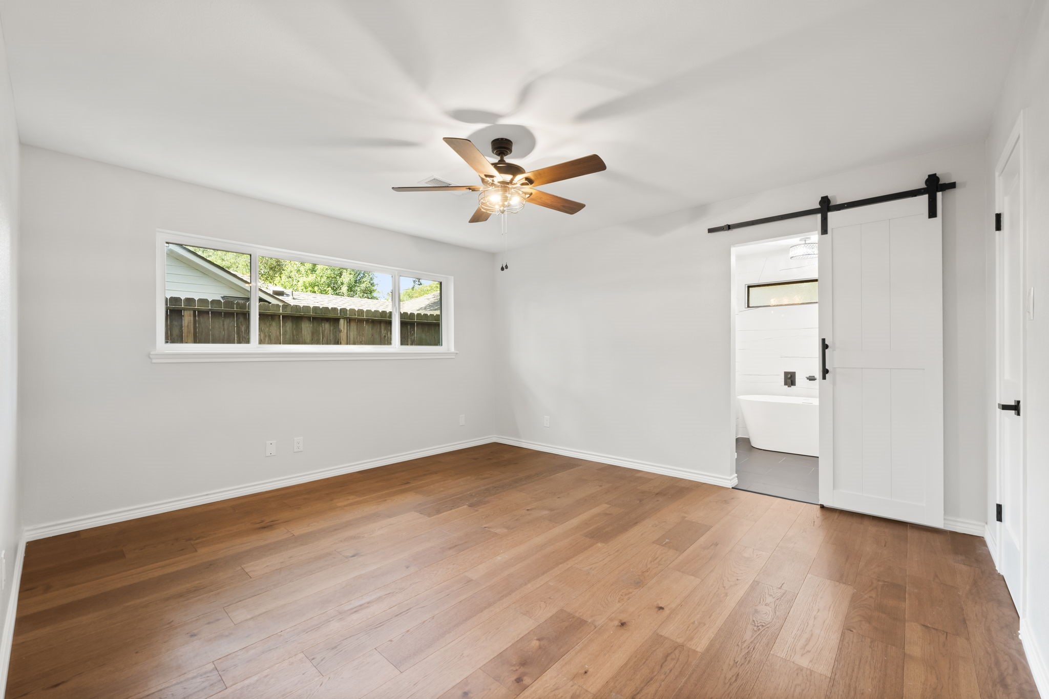 2535 Southwick Street Houston, TX 77080 - Photo 15 of 26 a view of an empty room with a window and a ceiling fan