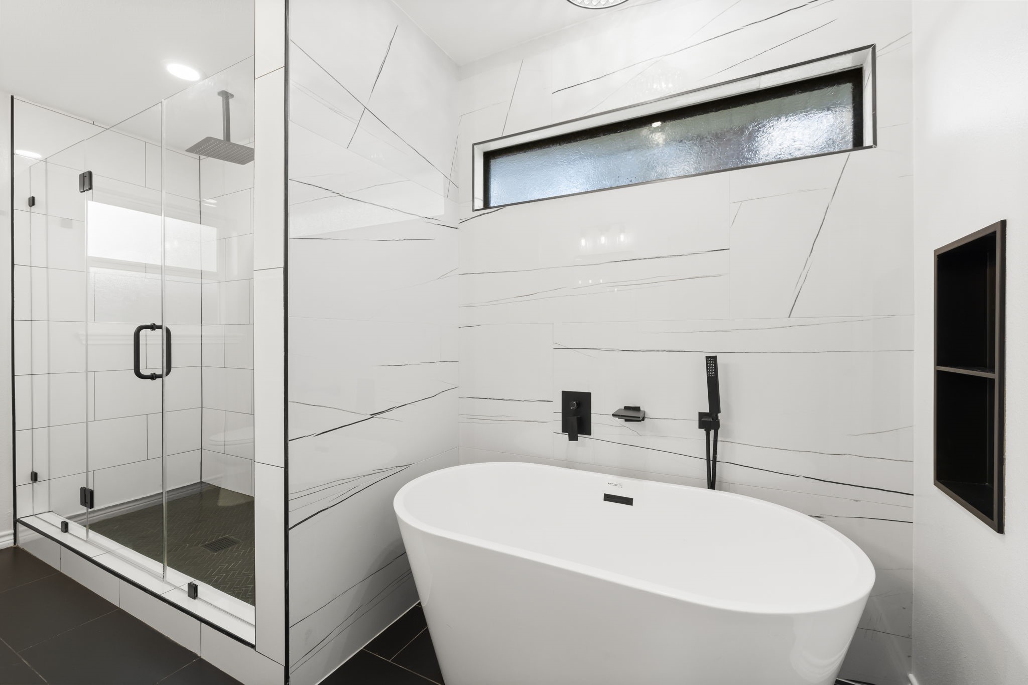 2535 Southwick Street Houston, TX 77080 - Photo 16 of 26 a bathroom with a tub and a shower