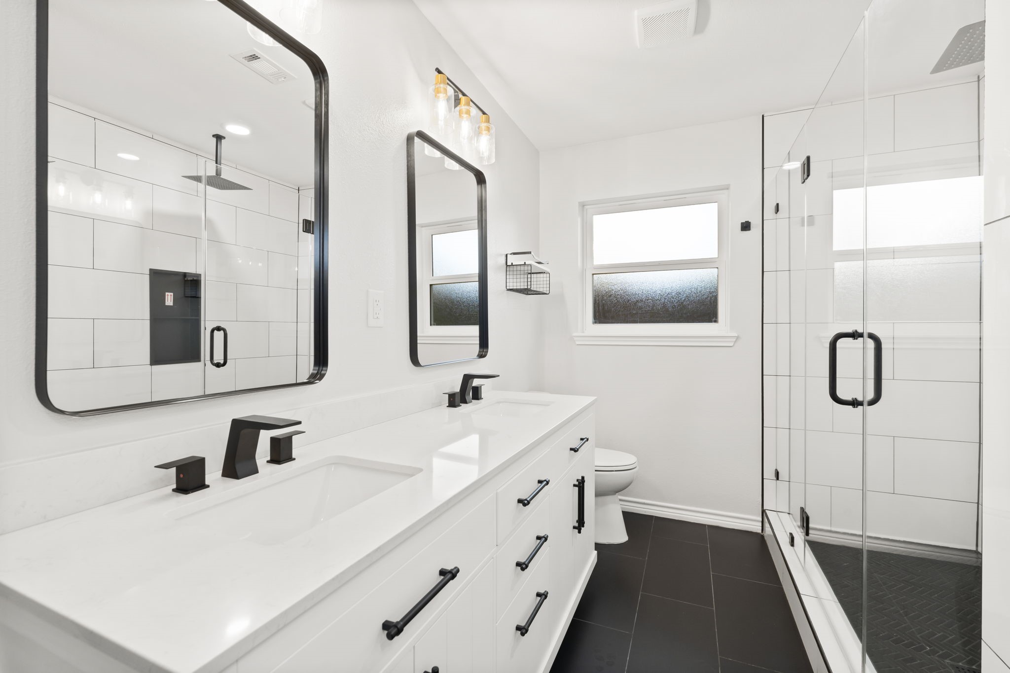 2535 Southwick Street Houston, TX 77080 - Photo 17 of 26 a bathroom with a double vanity sink mirror and shower