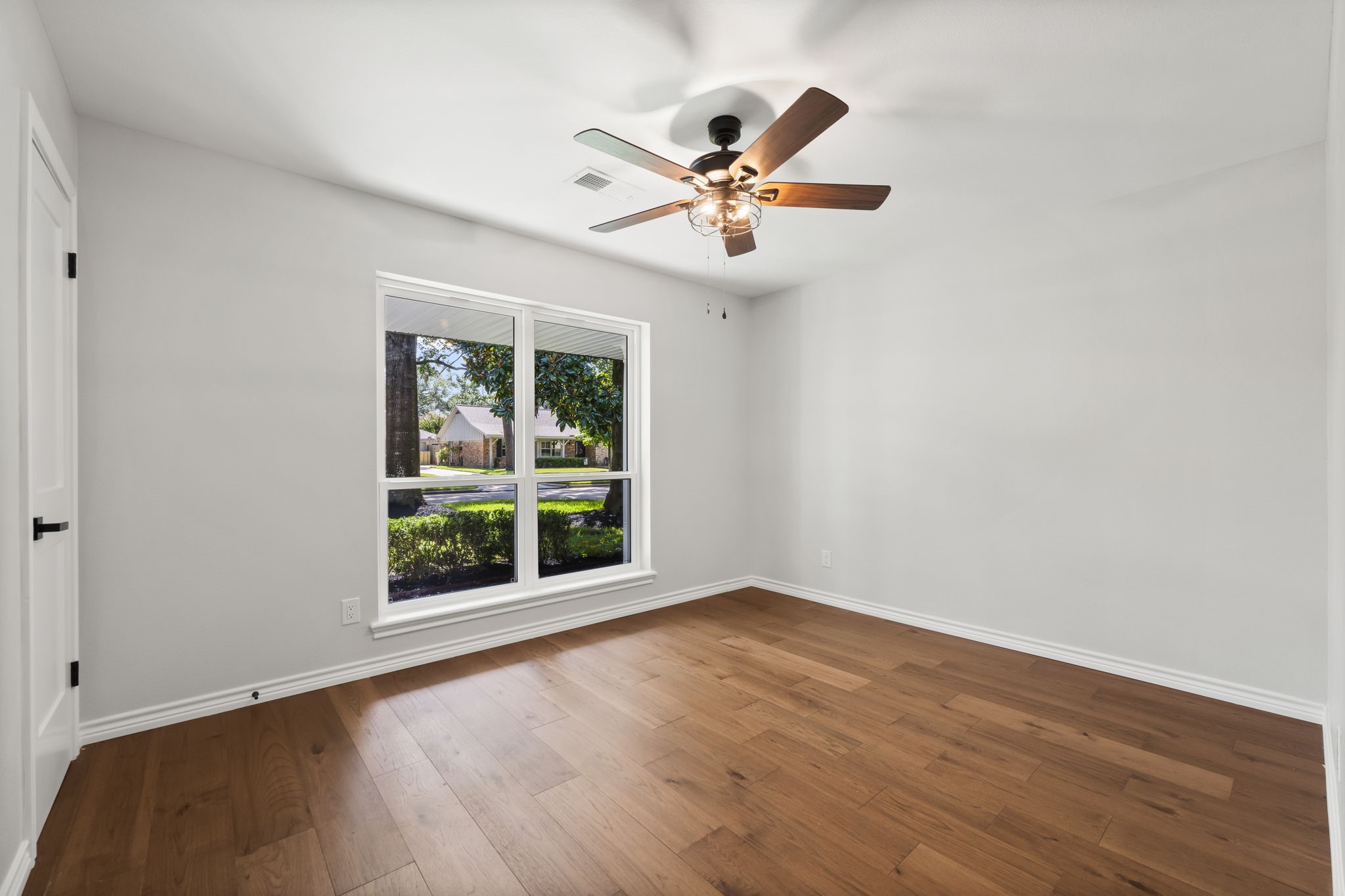 2535 Southwick Street Houston, TX 77080 - Photo 20 of 26 a view of an empty room with wooden floor and a window