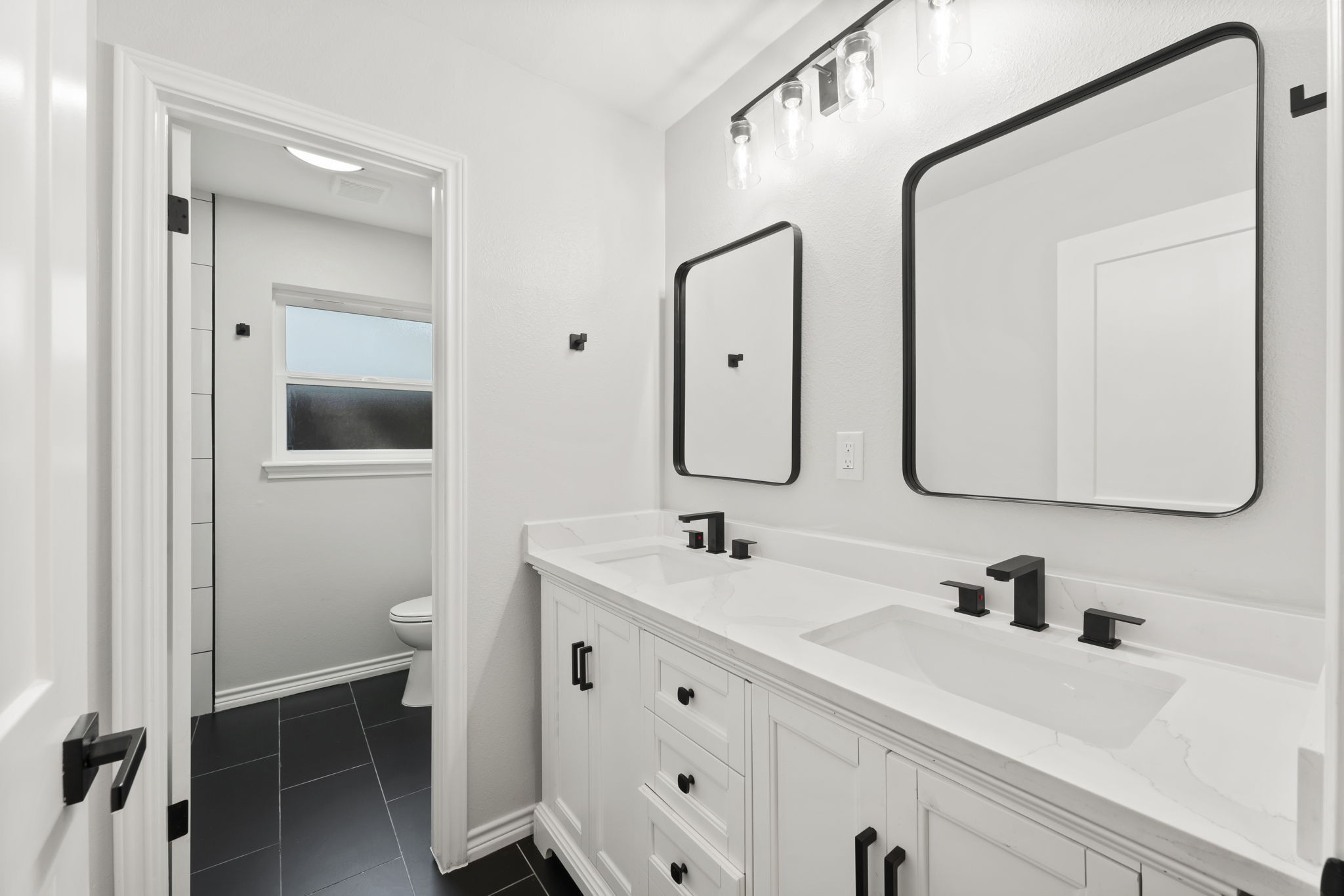 2535 Southwick Street Houston, TX 77080 - Photo 21 of 26 a bathroom with double vanity sink and a mirror