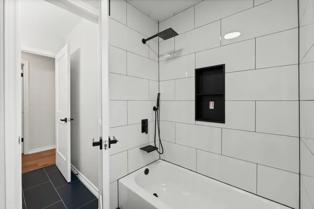 a bathroom with a bathtub and a shower