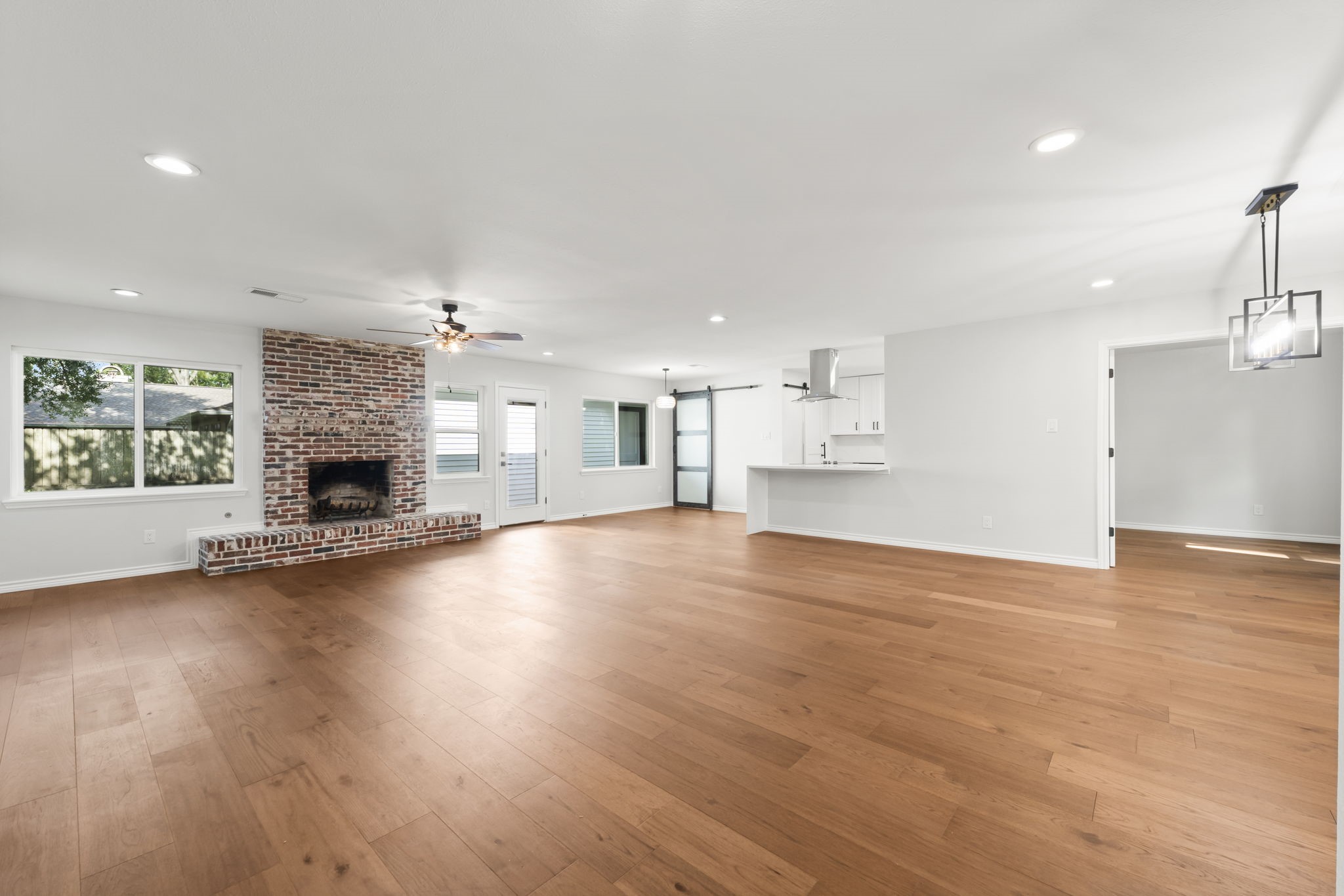 2535 Southwick Street Houston, TX 77080 - Photo 7 of 26 a view of empty room with wooden floor and fireplace