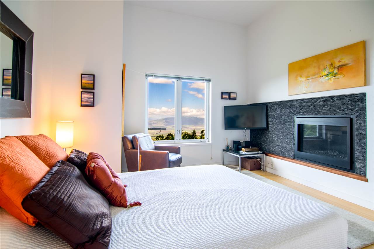 120-122 Ainakula Road Kula, HI 96790 - Photo 13 of 28 a bedroom with a bed and wooden floor