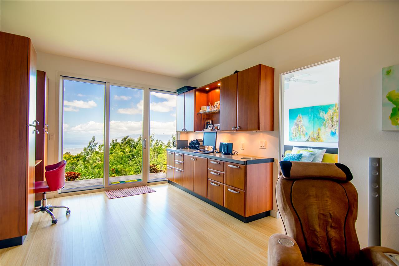 120-122 Ainakula Road Kula, HI 96790 - Photo 21 of 28 a kitchen with stainless steel appliances kitchen island wooden cabinets and entryway