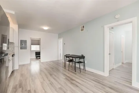 a view of a livingroom with wooden floor and a fireplace