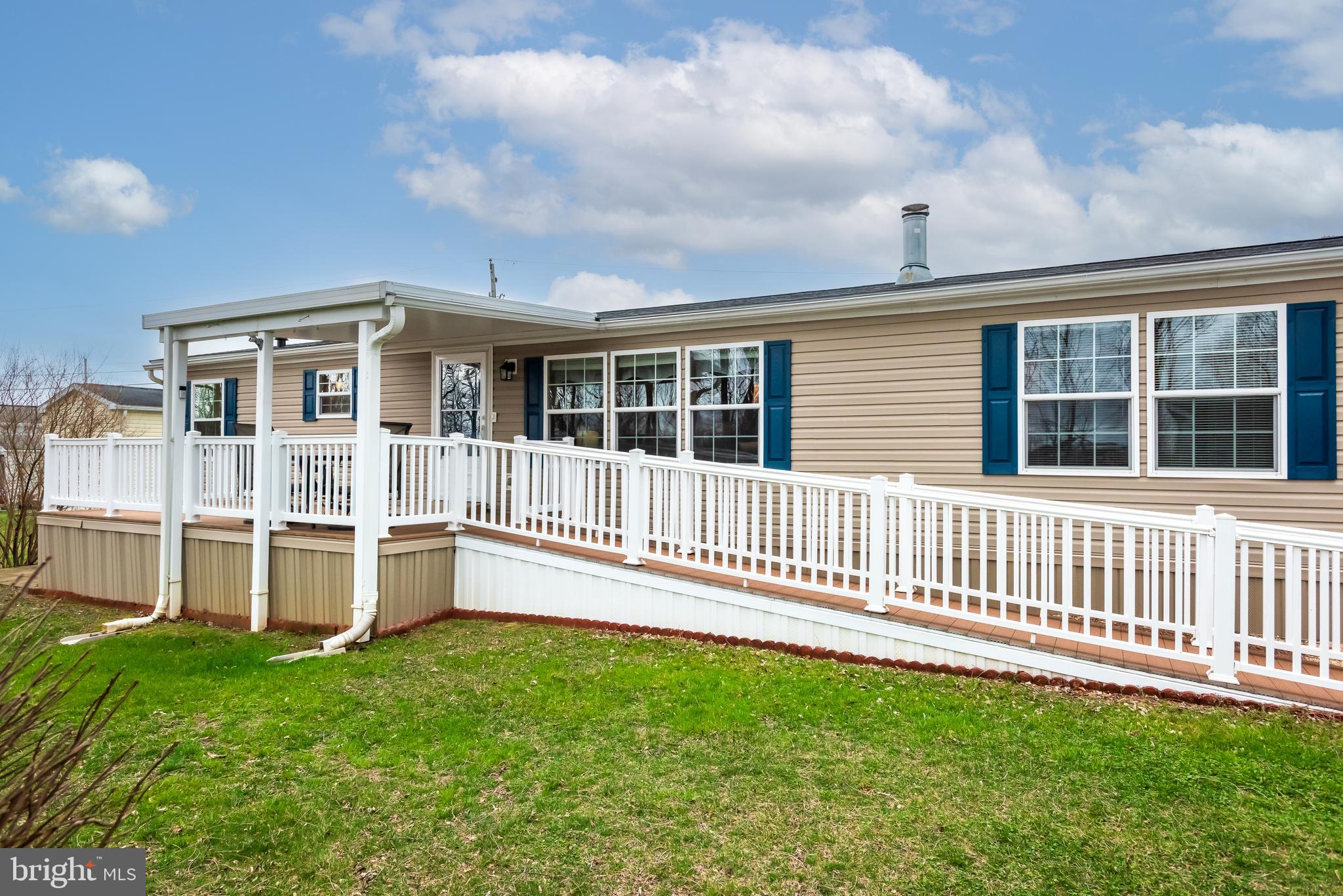a view of a house with a backyard and a deck