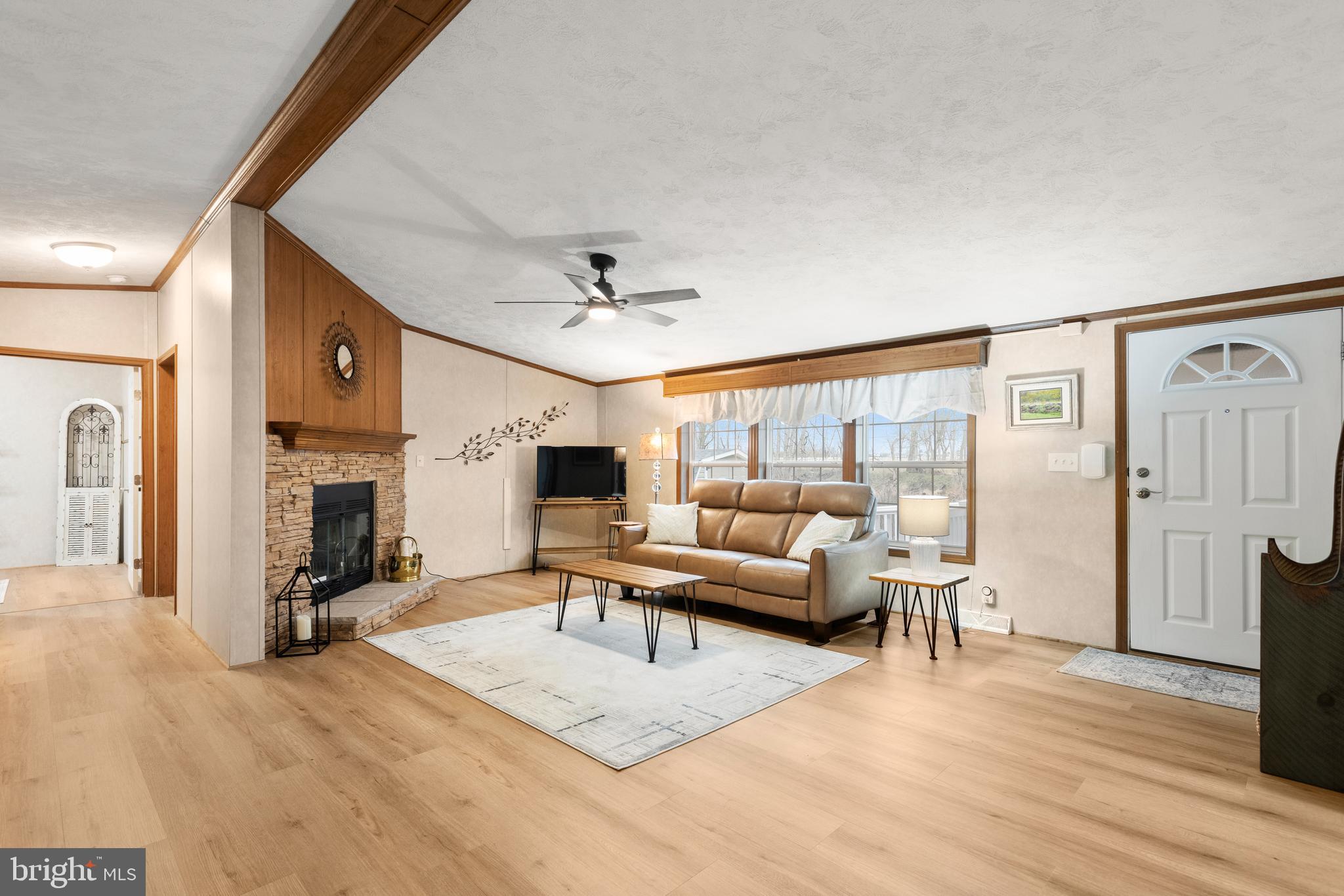 47 Janis Road Gordonville, PA 17529 - Photo 2 of 26 a living room with furniture a fireplace and a flat screen tv