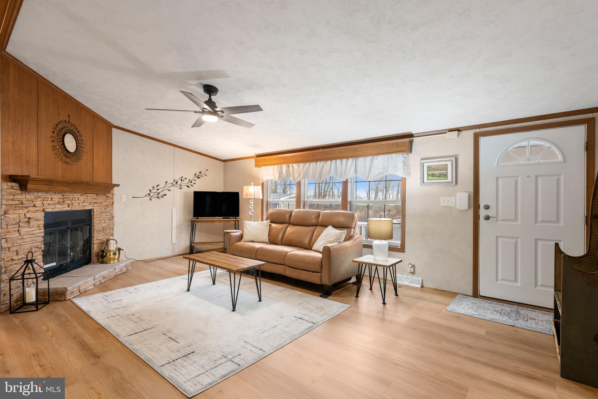 47 Janis Road Gordonville, PA 17529 - Photo 3 of 26 a living room with furniture a fireplace and a flat screen tv