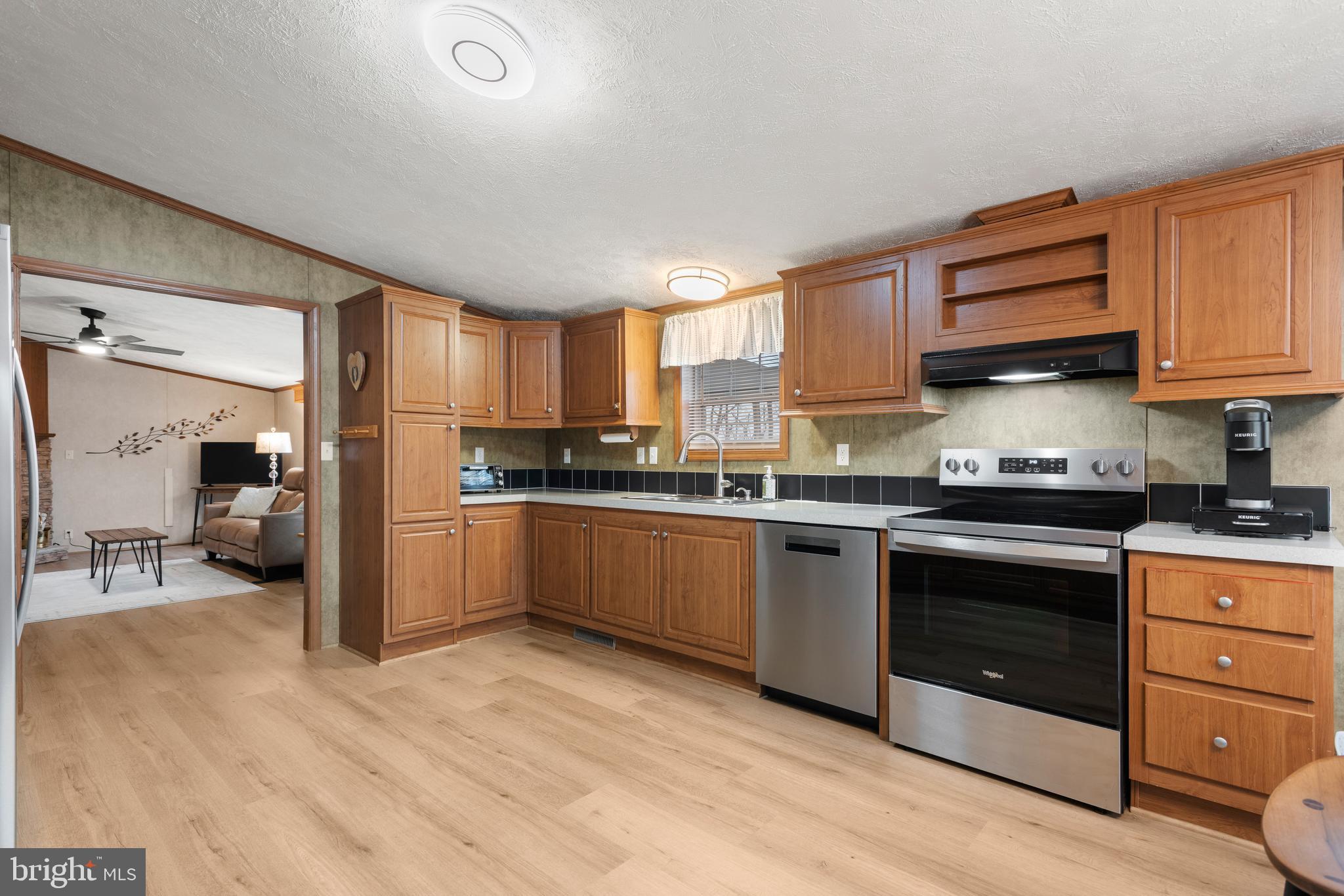 47 Janis Road Gordonville, PA 17529 - Photo 8 of 26 a kitchen with granite countertop a stove a sink and a refrigerator