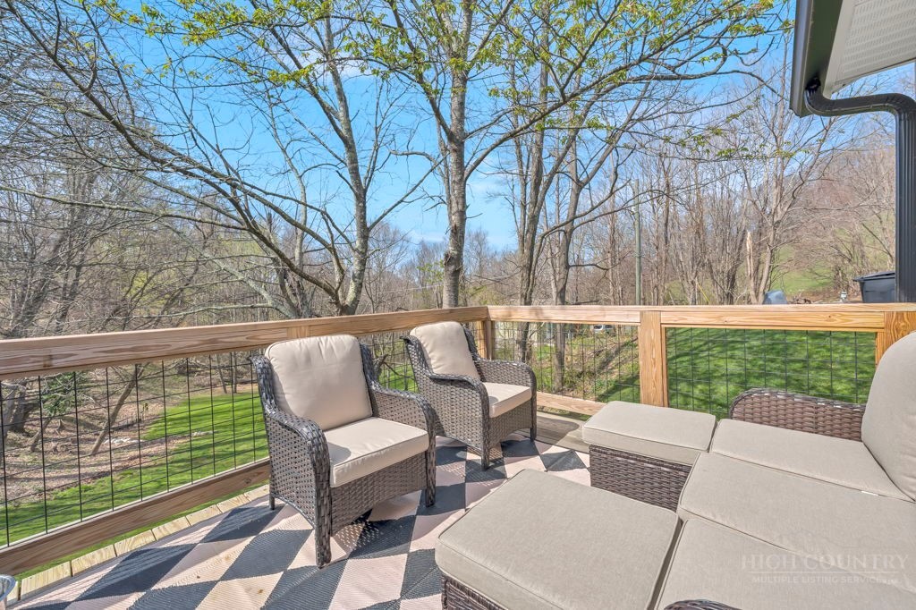 656 Mulatto Mountain Road West Jefferson, NC 28694 - Photo 15 of 35 a view of backyard with seating space and trees