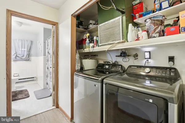 a utility room with stainless steel appliances granite countertop a stove and a refrigerator