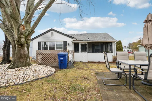 a front view of a house with a yard outdoor seating and garage