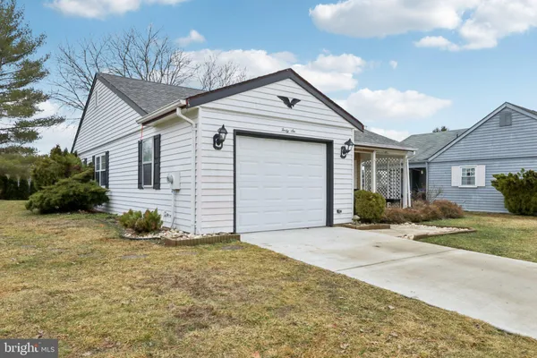 a view of a house with a yard and garage