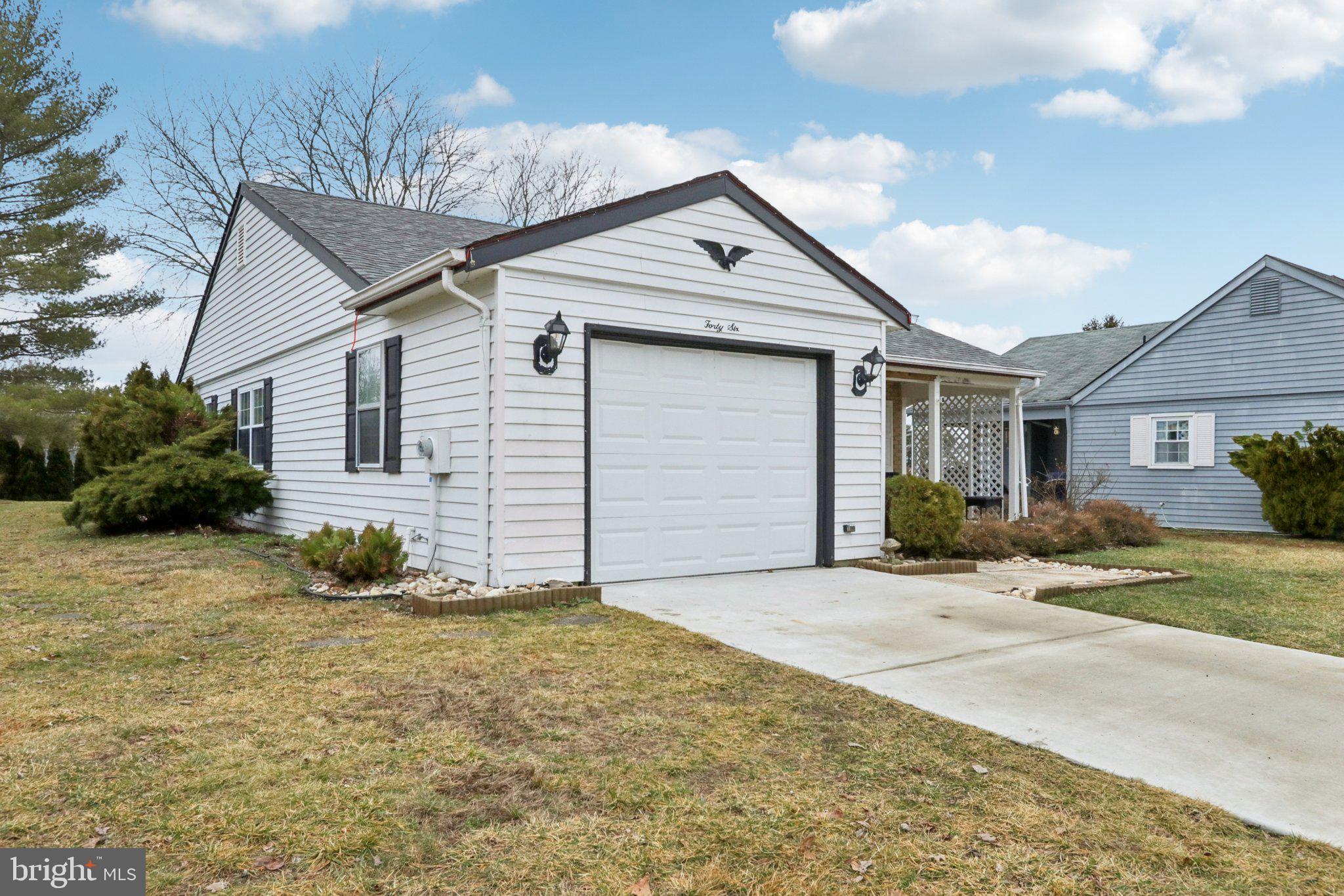 46 Gramercy Place Southampton, NJ 08088 - Photo 4 of 37 a view of a house with a yard and garage