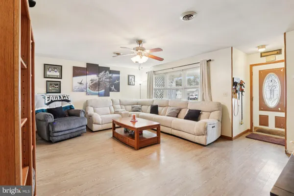 a living room with furniture and a chandelier