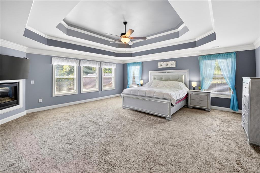 2300 Tucker Mill Road Southwest Conyers, GA 30094 - Photo 20 of 45 a spacious bedroom with a bed and a ceiling fan