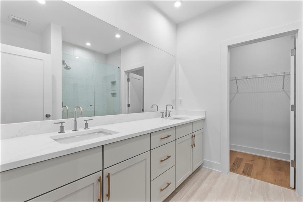 201 New Street, Unit 1204 Decatur, GA 30030 - Photo 17 of 28 a bathroom with double sink and a mirror