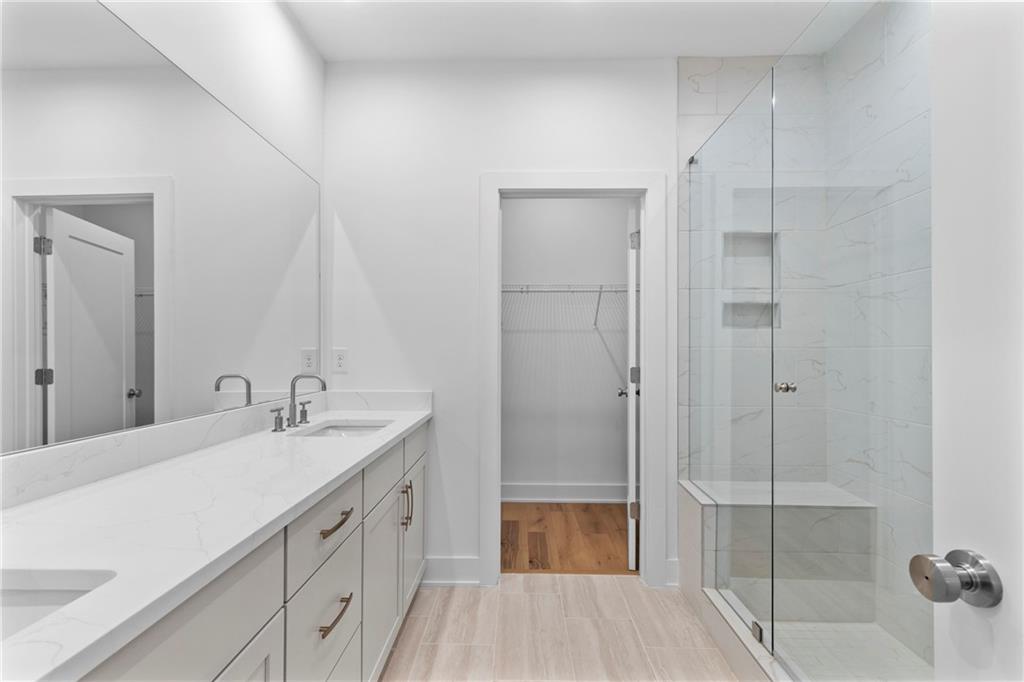 201 New Street, Unit 1204 Decatur, GA 30030 - Photo 18 of 28 a spacious bathroom with a shower sink and mirror