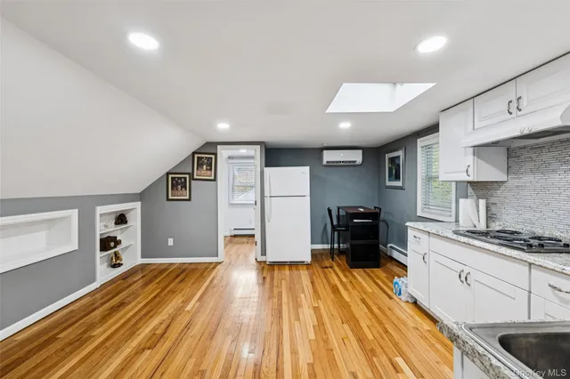 a kitchen with stainless steel appliances kitchen island granite countertop a stove and a refrigerator