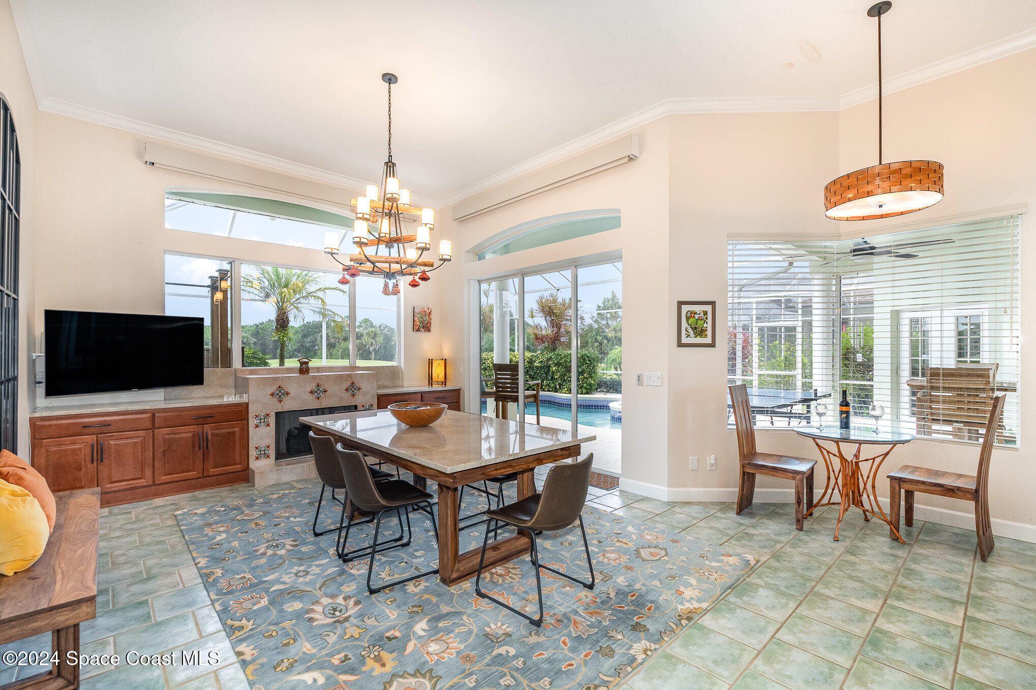 4321 Collingtree Drive Rockledge, FL 32955 - Photo 11 of 70 a dining room with wooden floor a chandelier a wooden table and chairs