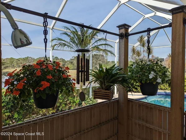 a view of swimming pool with outdoor seating and plants