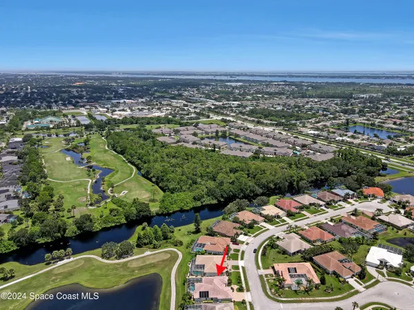 a kitchen with stainless steel appliances granite countertop a refrigerator a sink dishwasher a stove and a refrigerator with wooden cabinets