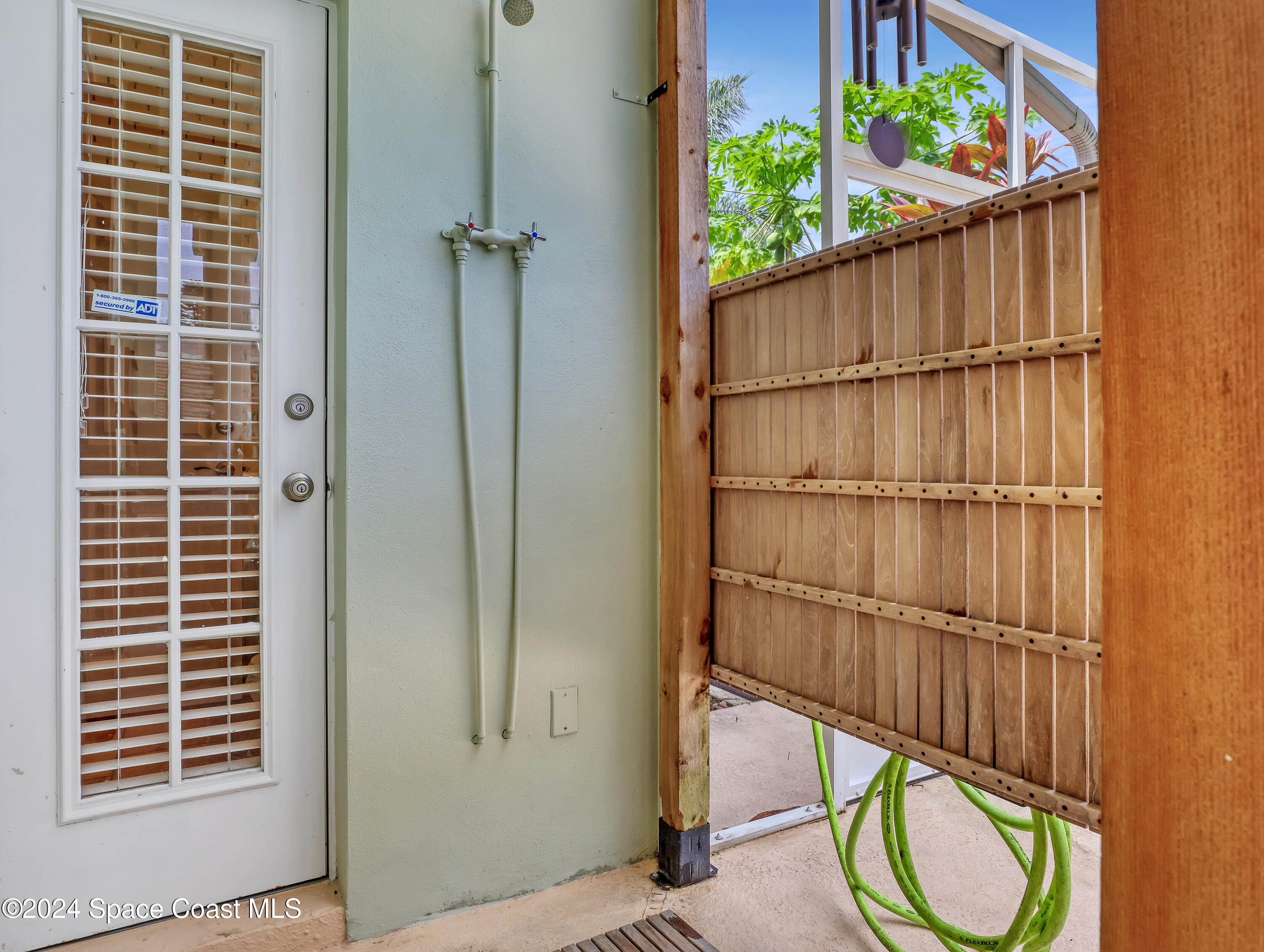 4321 Collingtree Drive Rockledge, FL 32955 - Photo 45 of 70 a view of a porch with wooden floor and a potted plant