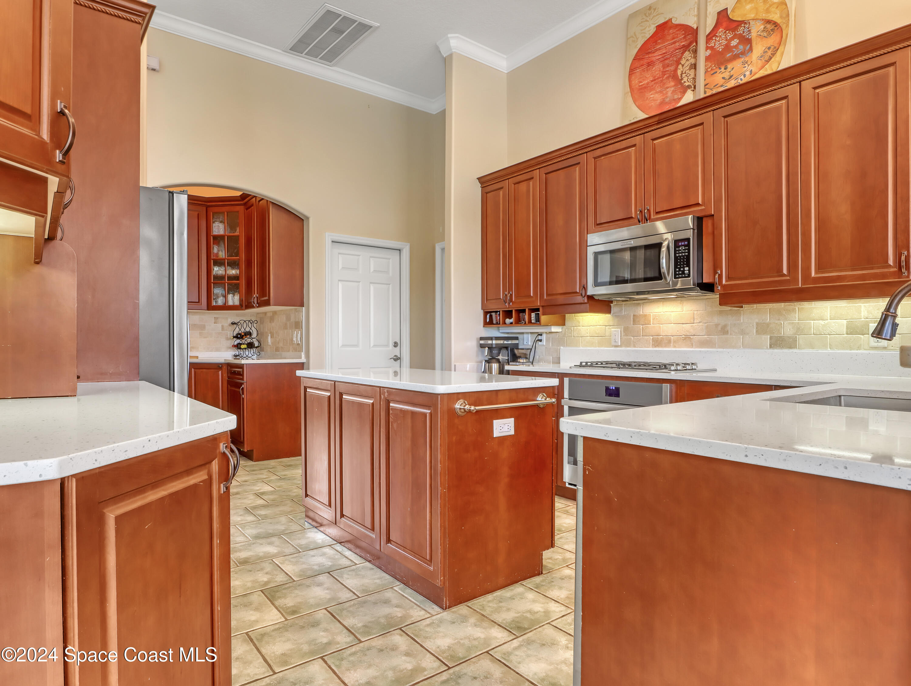 4321 Collingtree Drive Rockledge, FL 32955 - Photo 55 of 70 a kitchen with stainless steel appliances a stove top oven a sink a microwave oven and a refrigerator