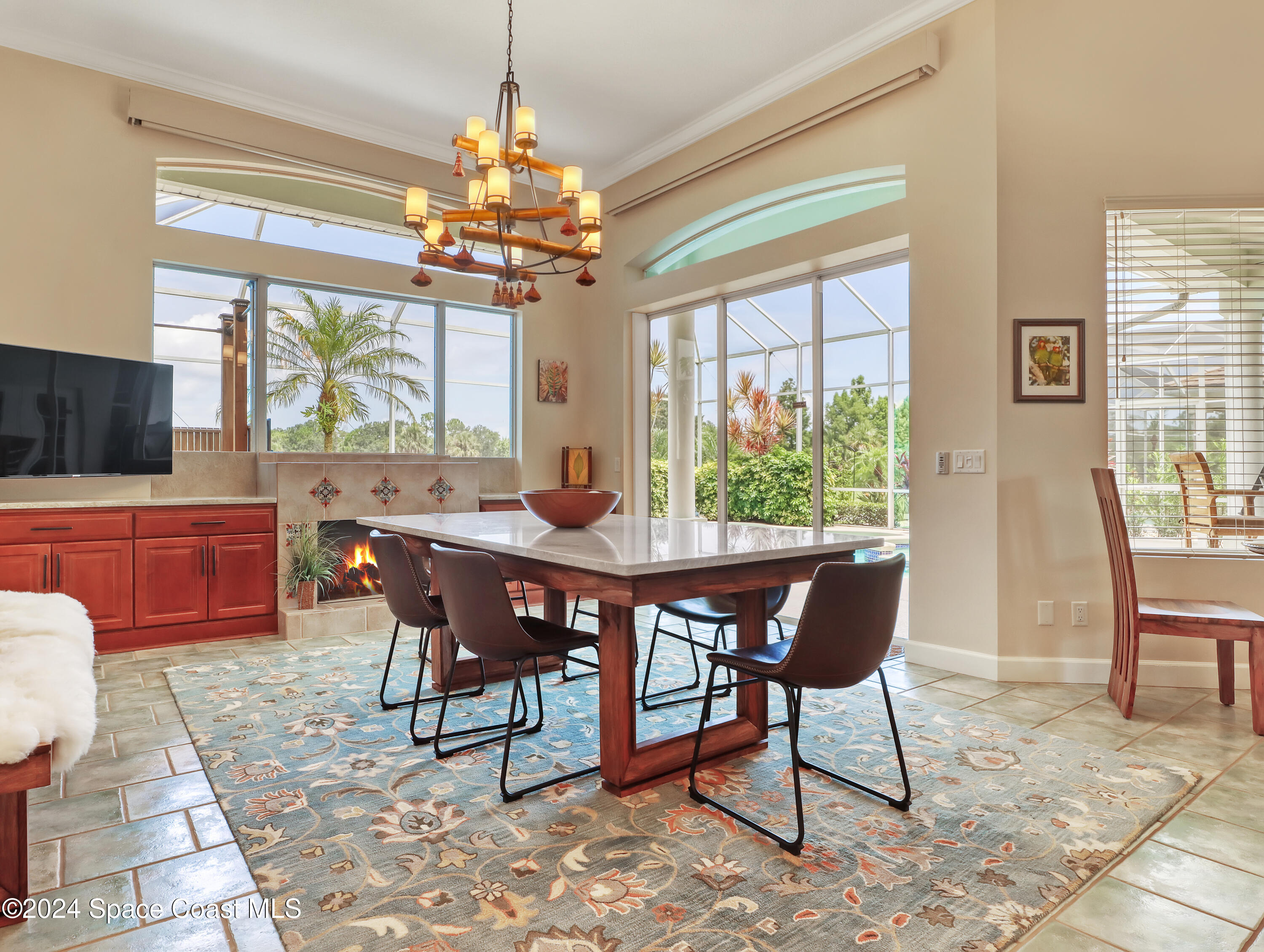4321 Collingtree Drive Rockledge, FL 32955 - Photo 61 of 70 a dining room with furniture a chandelier and wooden floor