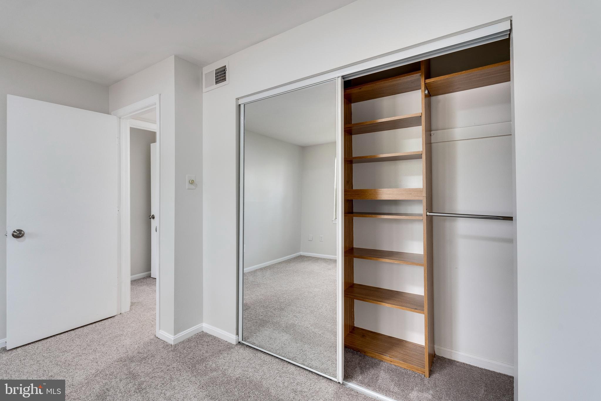 6 Normandy Square Court, Unit 2CB Silver Spring, MD 20906 - Photo 15 of 28 a room with walk in closet with empty racks