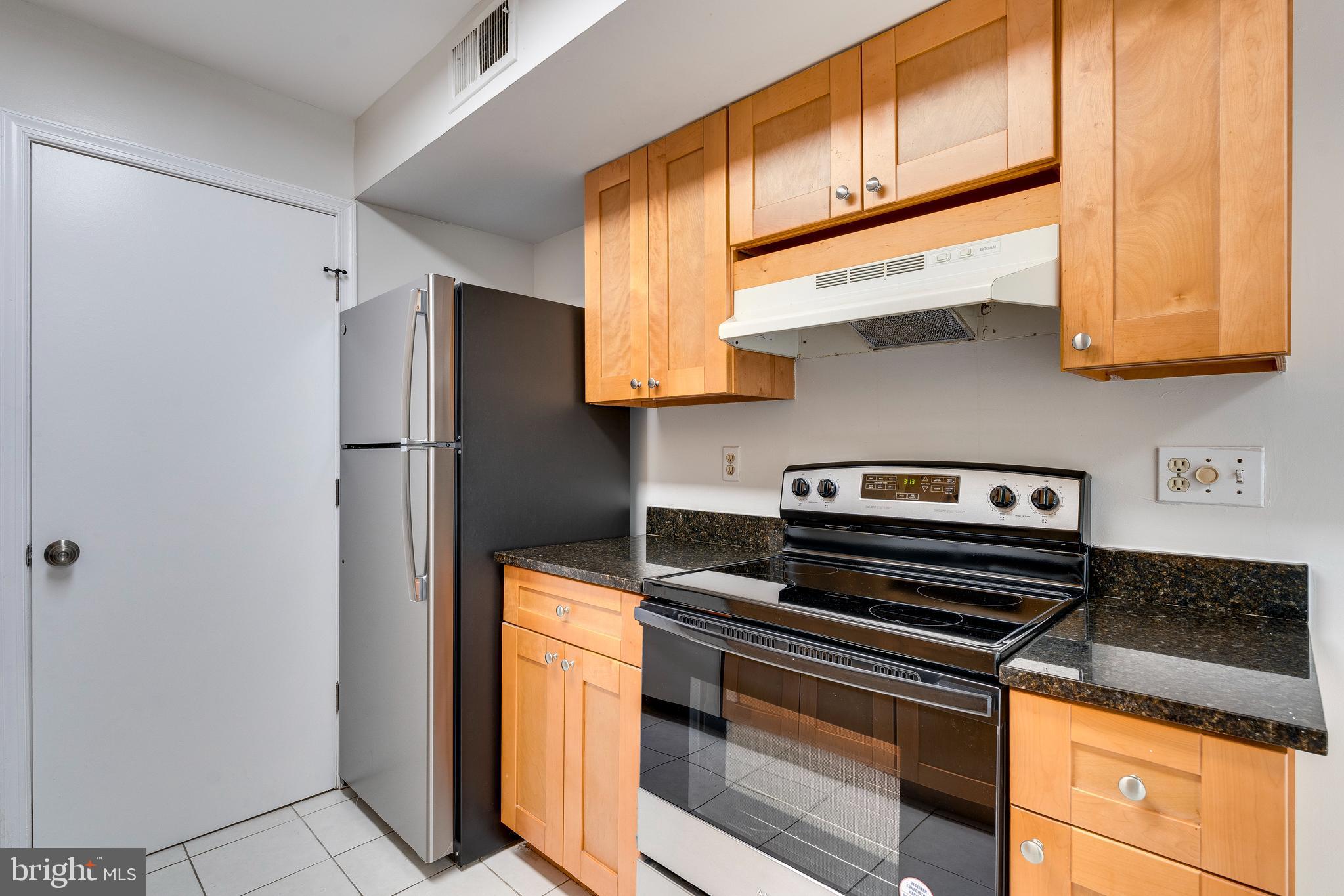 6 Normandy Square Court, Unit 2CB Silver Spring, MD 20906 - Photo 8 of 28 a kitchen with stainless steel appliances granite countertop a refrigerator and a stove