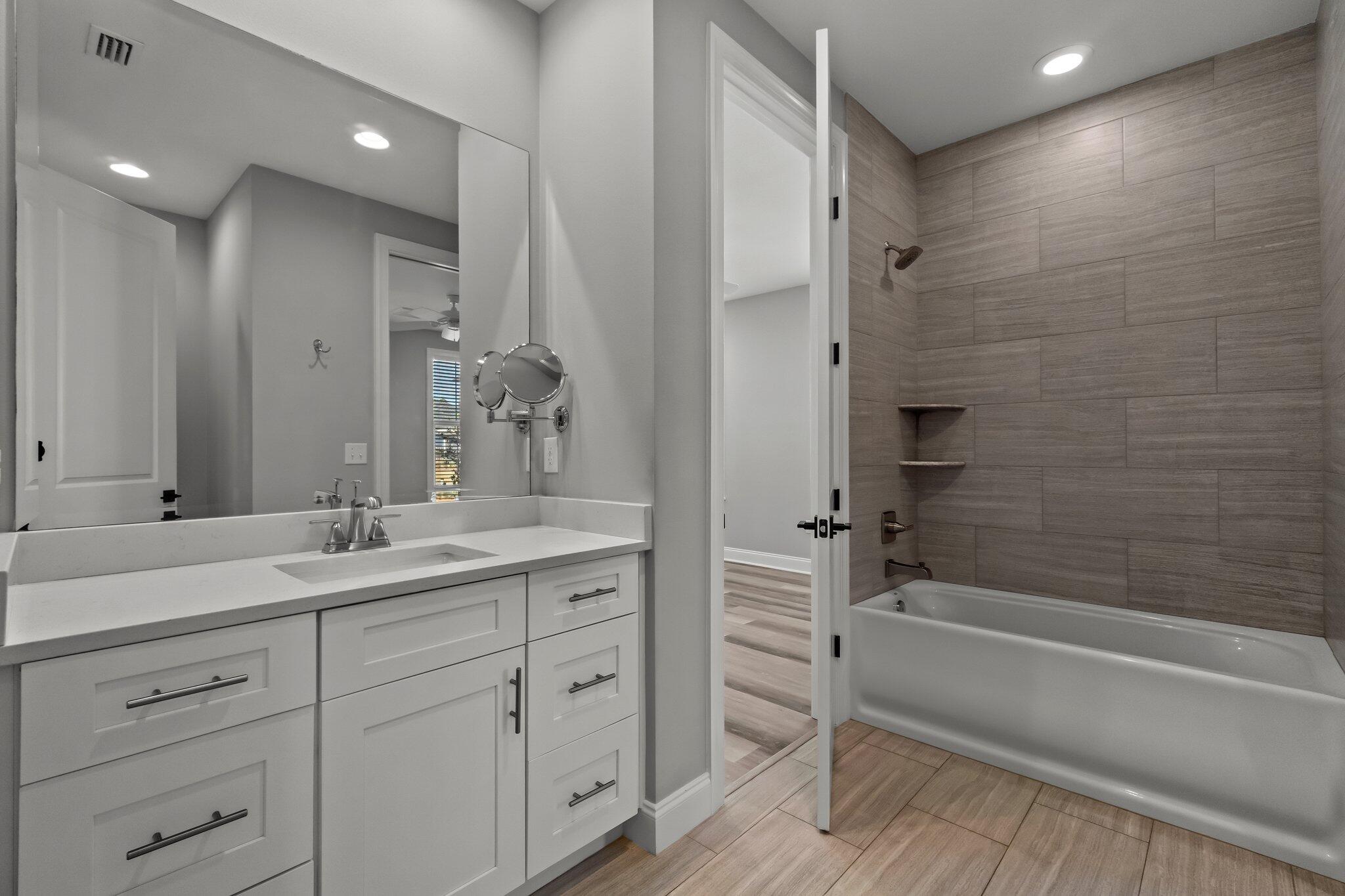 76 Conifer Ct Inlet Beach Inlet Beach, FL 32461 - Photo 15 of 25 a bathroom with a double vanity sink a mirror and a bathtub
