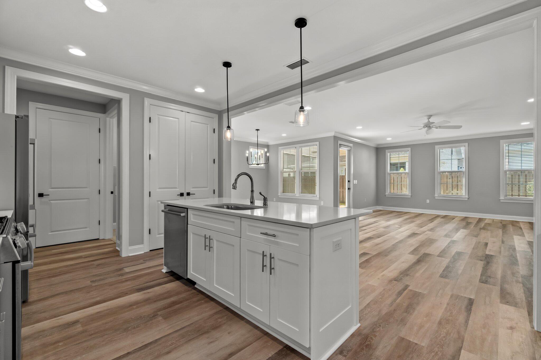76 Conifer Ct Inlet Beach Inlet Beach, FL 32461 - Photo 2 of 25 a large kitchen with a sink a counter space and wooden floors